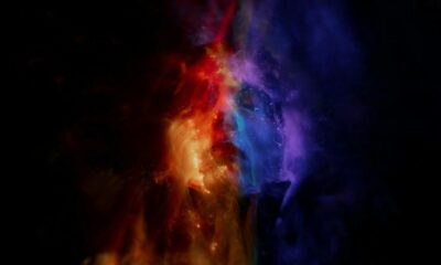 Abstract vibrant image featuring glowing red, orange, and blue light waves, creating a dynamic and conceptual design.