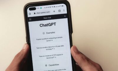 Close-up of hands holding a smartphone displaying the ChatGPT application interface on the screen.