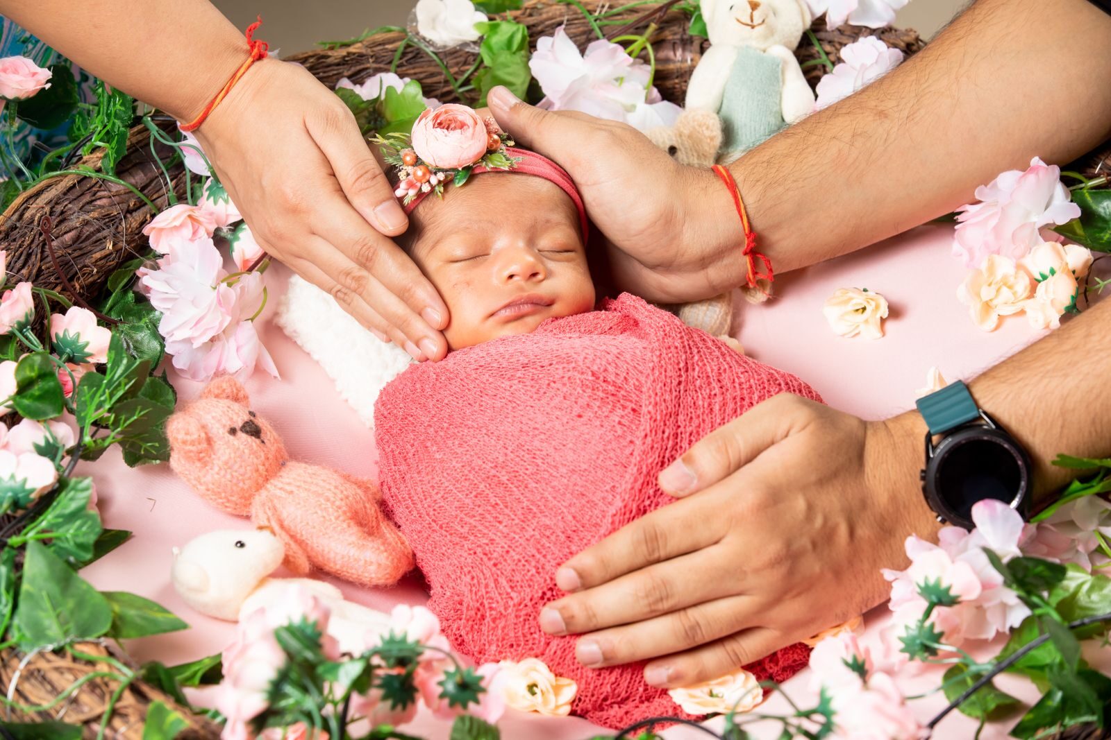 Sweet newborn wrapped in pink, nestled among floral decorations, symbolizing love and warmth.