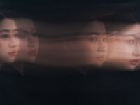 Surreal portrait of a woman with abstract motion blur effect, creating a dreamy, artistic look.