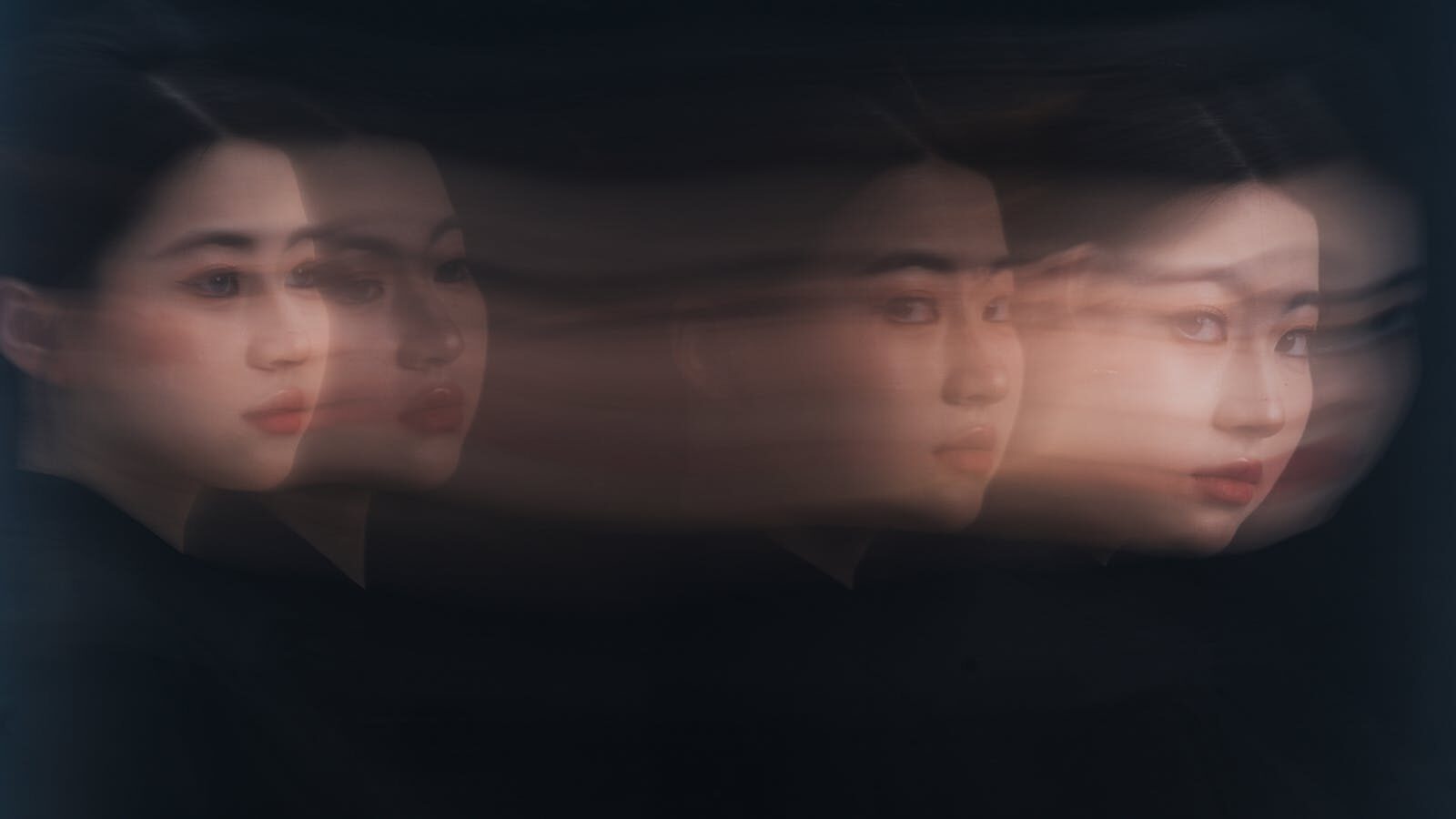 Surreal portrait of a woman with abstract motion blur effect, creating a dreamy, artistic look.