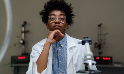 Portrait of a thoughtful scientist with eyeglasses in a laboratory setting.