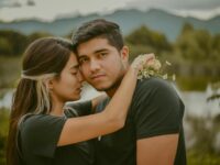 A young couple shares a tender embrace in San Cristóbal de las Casas, Mexico, with a scenic backdrop.